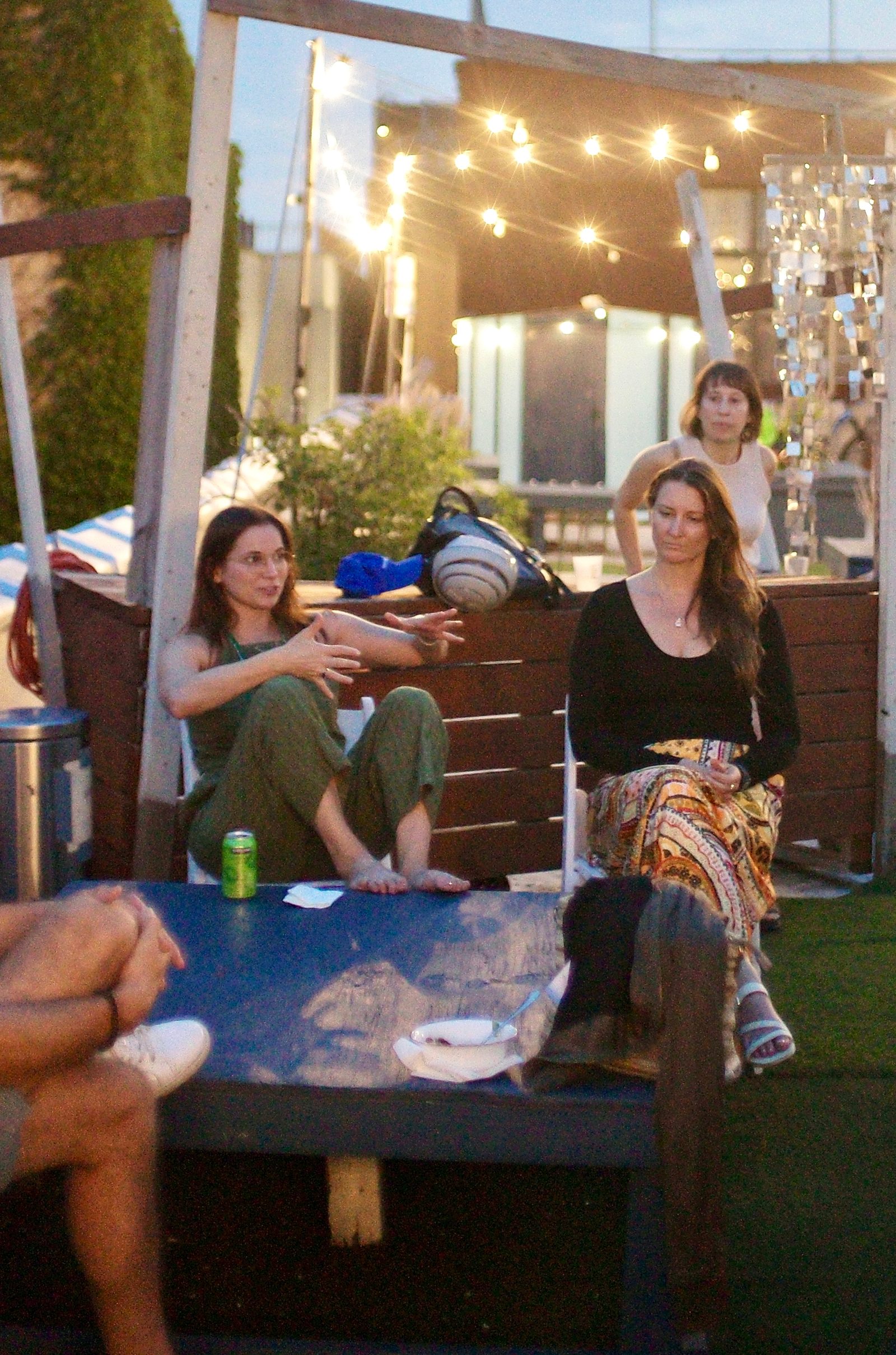Two attendees keep the conversation going on the rooftop after the workshop ends.