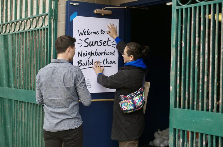 Hanging the welcome sign at the hall's front door