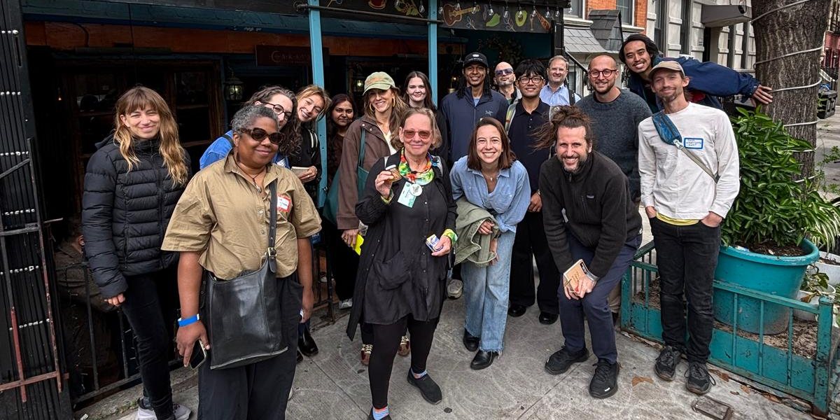 The walkers outside Caravan of Dreams on East 6th Street at the end of the tour, Wendy Brawer in the middle with her Green Map scarf.