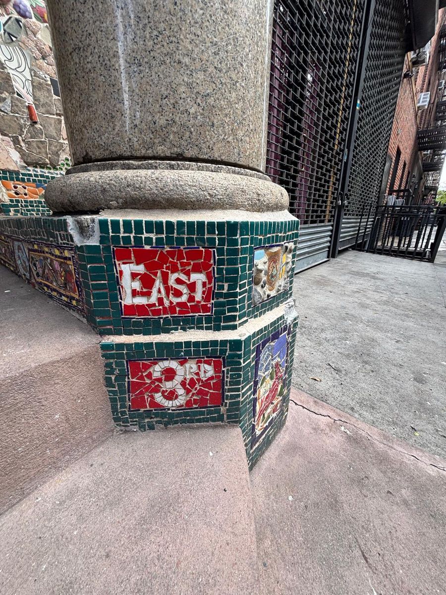 One of Jim Power's mosaic lampposts on East 3rd Street, tiled with the street name.