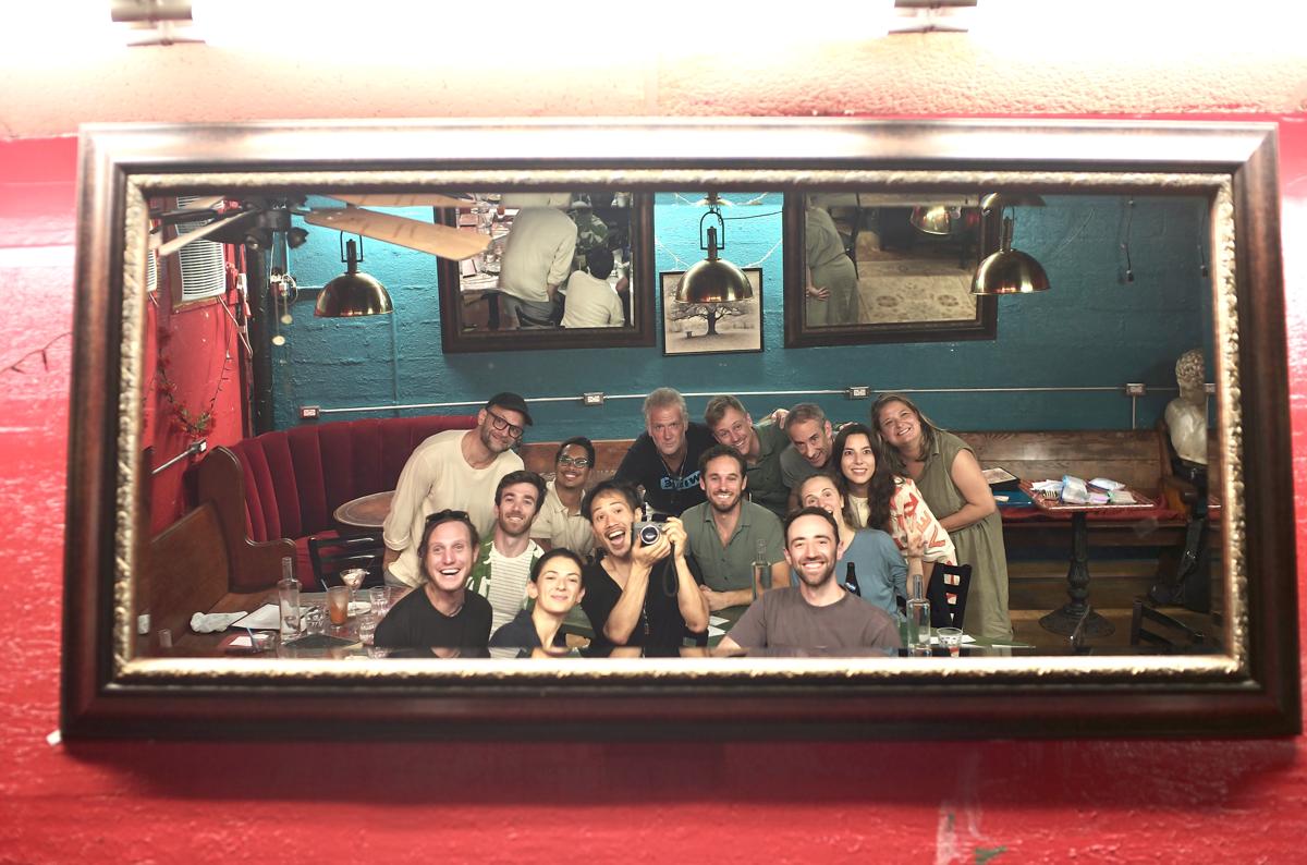 A group gathered in the Dream Room, photographed in the framed mirror