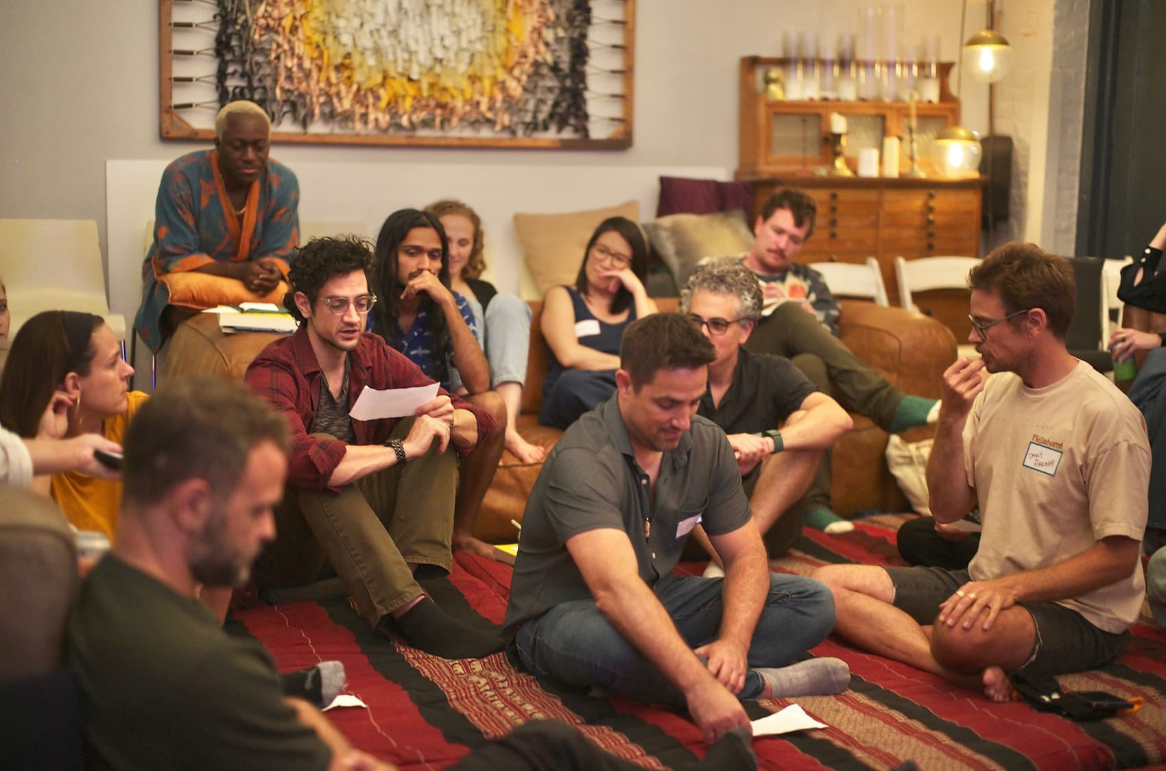 A war-games circle on the rug, scenario sheets in hand, the room leaning in.
