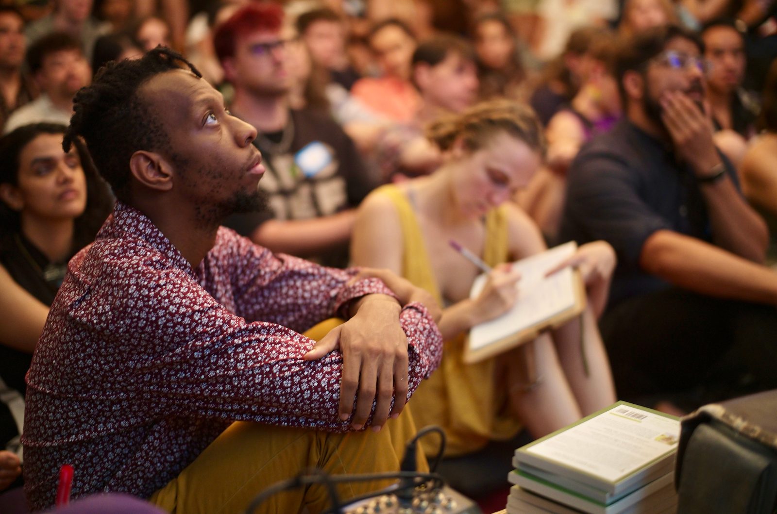 A participant sitting forward with a hand at his chin, working through the argument.
