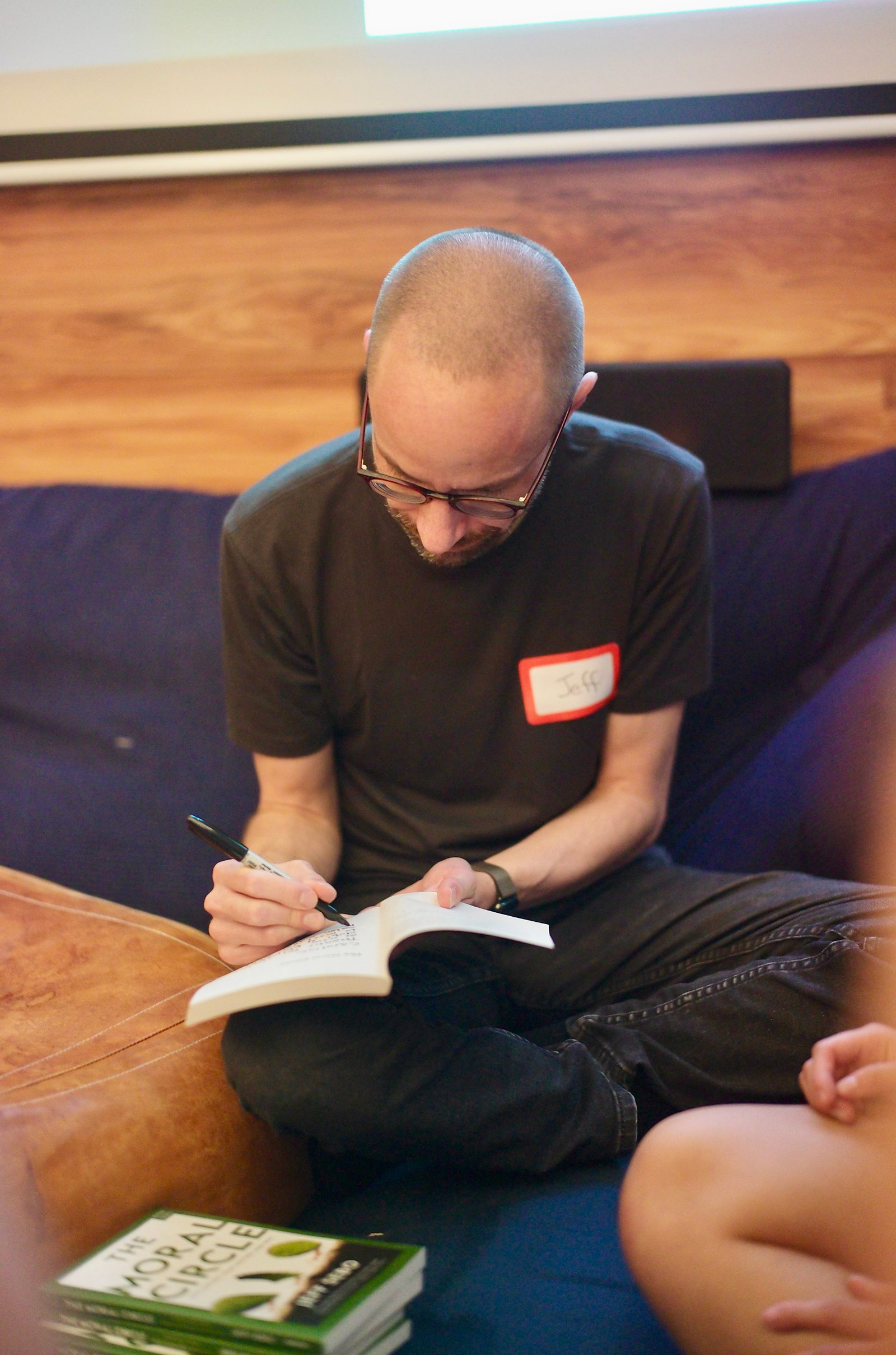 Jeff Sebo signing a copy of The Moral Circle during the break. He brought twenty and donated them.