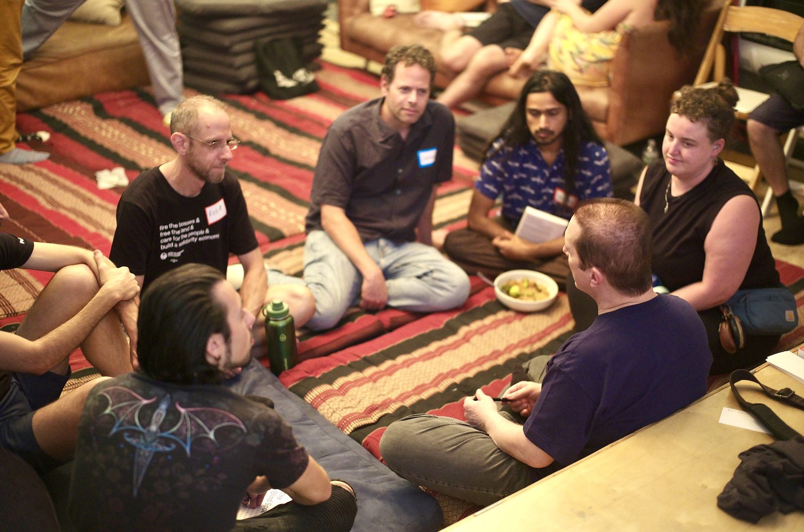 A breakout group on the rug during the ten minutes on one question: how do we dig ourselves out of an oligarchy?